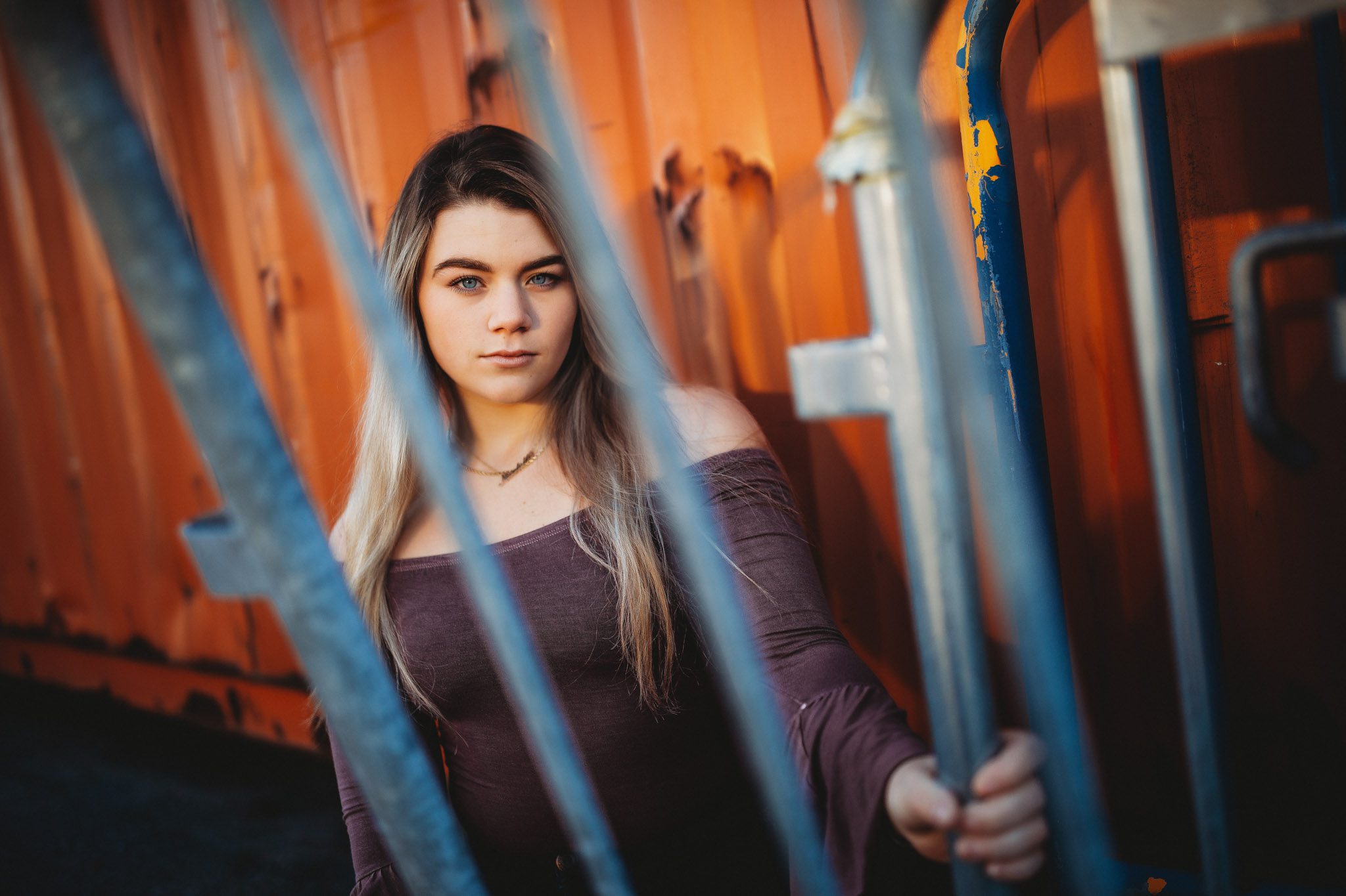 Edgy urban senior portrait of a young woman with a shipping container in Massachusetts photographed by Sean Wytrwal of J&S Photography